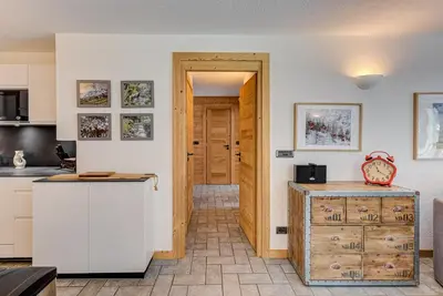 a kitchen with white cabinets and a wooden door at Apartment Winn, Alpes Travel, Central Chamonix, Sleeps 6 in Chamonix-Mont-Blanc