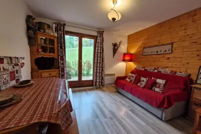 a living room with a red couch in a bedroom at Apartment with garden in Demi-Quartier in Demi-Quartier