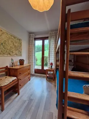 a bedroom with two bunk beds and a window at Apartment with garden in Demi-Quartier in Demi-Quartier