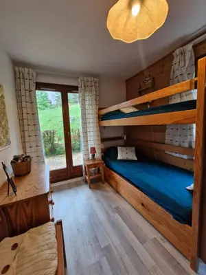 a bedroom with bunk beds and a large window at Apartment with garden in Demi-Quartier in Demi-Quartier