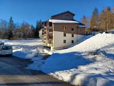 a building with a lot of snow in front of it at studio familial 4 couchages in Arâches-la-Frasse
