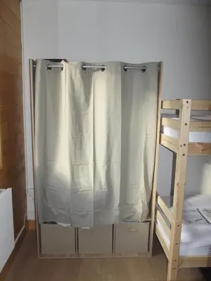 a shower curtain in a room next to a bunk bed at studio familial 4 couchages in Arâches-la-Frasse
