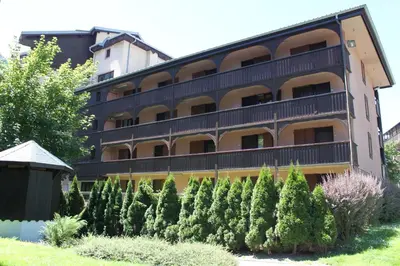 a building with a bunch of trees in front of it at Apartment Jonquille 3 - A Comfortable Chamonix Haven in Chamonix-Mont-Blanc