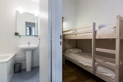 a bathroom with a bunk bed next to a sink and a mirror at Apartment Jonquille 3 - A Comfortable Chamonix Haven in Chamonix-Mont-Blanc