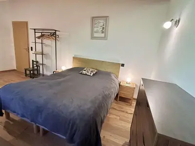 a bedroom with a large bed and a dresser at Appartement 3 Pièces, 4-6 Couchages, Vue Montagne, Parking Privé - FR-1-597-192 in Combloux