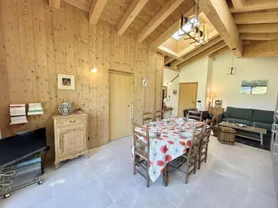 a dining room with a table with chairs and a couch at Appartement 3 Pièces, 4-6 Couchages, Vue Montagne, Parking Privé - FR-1-597-192 in Combloux