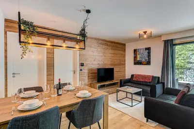 a living room with a table and a couch at Mazot de Kayla, Alpes Travel, Les Houches, Sleeps 4 in Les Houches