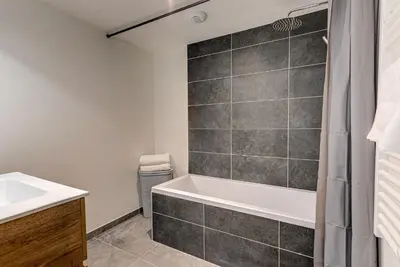 a bathroom with a tub and a sink at Mazot de Kayla, Alpes Travel, Les Houches, Sleeps 4 in Les Houches