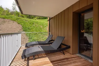 a couple of chairs sitting on a deck at Mazot de Kayla, Alpes Travel, Les Houches, Sleeps 4 in Les Houches