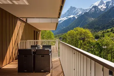 a balcony with chairs and a view of mountains at Mazot de Kayla, Alpes Travel, Les Houches, Sleeps 4 in Les Houches