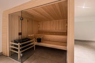 a sauna with wooden walls and a glass door at Mazot de Kayla, Alpes Travel, Les Houches, Sleeps 4 in Les Houches
