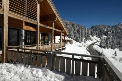 a log cabin in the snow with a rail at Résidence Les Portes du Grand Massif - Flaine in Flaine