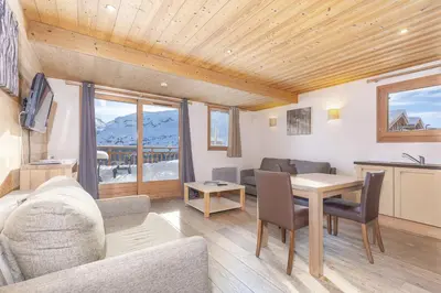 a living room with a table and a dining room at Résidence Les Portes du Grand Massif - Flaine in Flaine