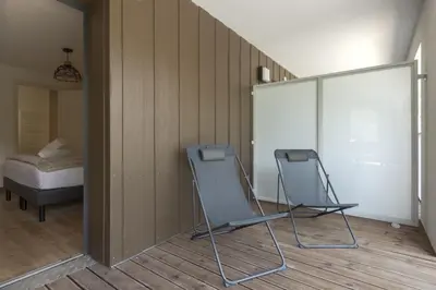 two folding chairs in a room with a bed at Le mazot de Kayla - Espace bien être, picine in Les Houches