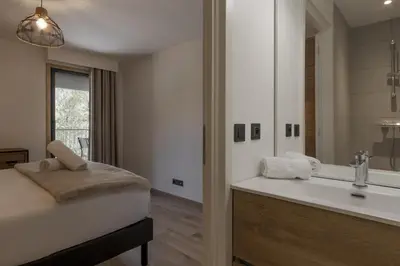 a bathroom with a bed and a tub and a sink at Le mazot de Kayla - Espace bien être, picine in Les Houches