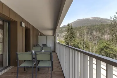 a balcony with chairs and a view of the mountains at Le mazot de Kayla - Espace bien être, picine in Les Houches