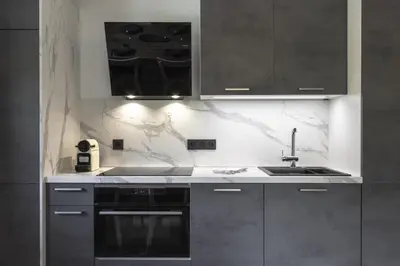 a kitchen with a sink and a stove at Le mazot de Kayla - Espace bien être, picine in Les Houches