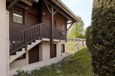 a house with a balcony on the side of it at Prarion Lac - Pied des pistes - Vue montagne in Les Houches