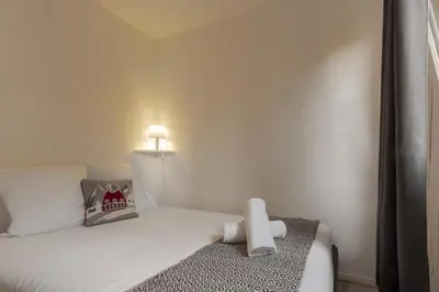 a bedroom with a bed with a teddy bear on it at Prarion Lac - Pied des pistes - Vue montagne in Les Houches