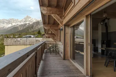 a wooden balcony with a view of mountains at Trabets 2 - Vue Montagne - 150m des Remontees in Les Houches