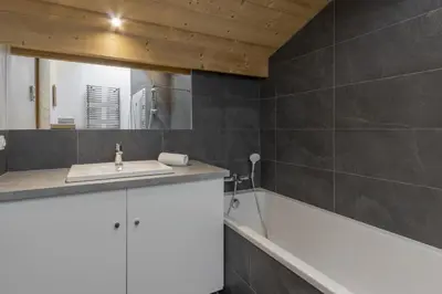 a bathroom with a sink and a bath tub at Trabets 2 - Vue Montagne - 150m des Remontees in Les Houches