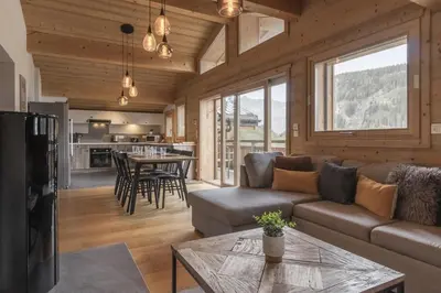 a living room with a couch and a table at Trabets 2 - Vue Montagne - 150m des Remontees in Les Houches
