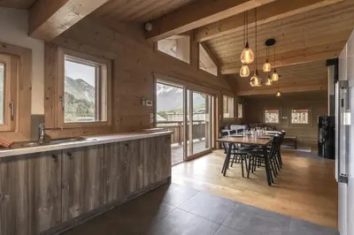 a kitchen and dining room with a table and chairs at Trabets 2 - Vue Montagne - 150m des Remontees in Les Houches