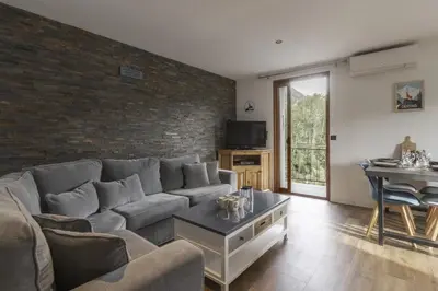 a living room with a couch and a table at Tout Schuss - Centre St Gervais - Vue degagee in Saint-Gervais-les-Bains