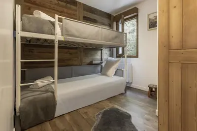 a bedroom with bunk beds in a house at Tout Schuss - Centre St Gervais - Vue degagee in Saint-Gervais-les-Bains