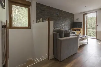 a living room with a couch and a tv at Tout Schuss - Centre St Gervais - Vue degagee in Saint-Gervais-les-Bains
