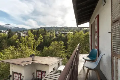 a balcony with two chairs and a view of the mountains at Tout Schuss - Centre St Gervais - Vue degagee in Saint-Gervais-les-Bains