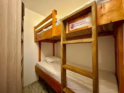 a couple of bunk beds in a room at appartement 4 personnes au coeur de la station des carroz d arâches in Arâches-la-Frasse