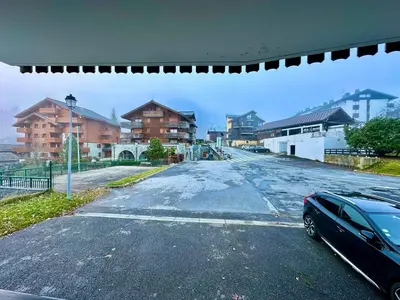 an empty street with a car parked on it at appartement 4 personnes au coeur de la station des carroz d arâches in Arâches-la-Frasse
