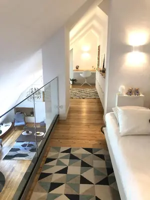 a room with a bed and a hallway with a bathroom at Duplex avec vue Mont-Blanc, centre ville Chamonix in Chamonix-Mont-Blanc