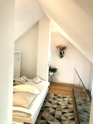 a bedroom with a bed and a checkered floor at Duplex avec vue Mont-Blanc, centre ville Chamonix in Chamonix-Mont-Blanc