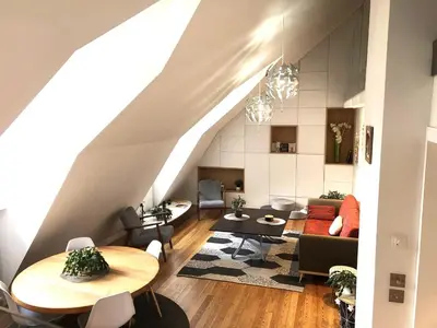 a living room with a couch and a table at Duplex avec vue Mont-Blanc, centre ville Chamonix in Chamonix-Mont-Blanc