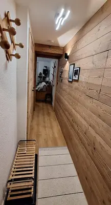 a room with a wooden wall with a bed in it at Cocon cozy, vue magique in Demi-Quartier