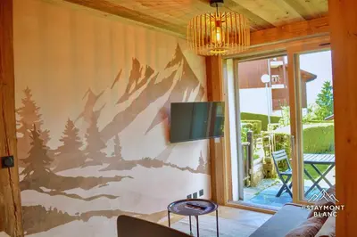 a wall with a painting of a forest on it at Nid douillet au pied du Tramway du MontBlanc à Saint-Gervais in Saint-Gervais-les-Bains