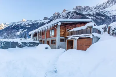 a log cabin in the mountains covered in snow at Chalet Zen - Sauna Hammam - Vue Mont-Blanc in Chamonix-Mont-Blanc
