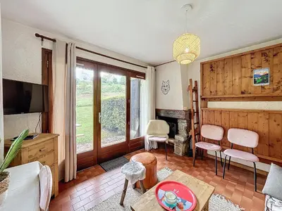 a living room with a television and a fireplace at Appartement 2 pièces au pied des pistes à Combloux - FR-1-560-162 in Combloux