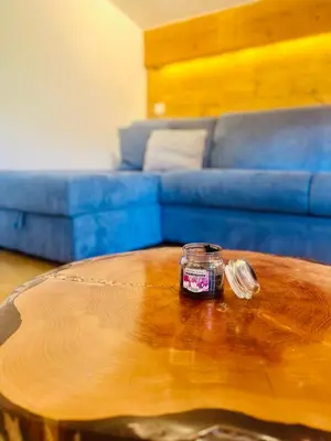 a jar on top of a wooden table in a living room at Elegant et cosy, Appt à la montagne in Combloux