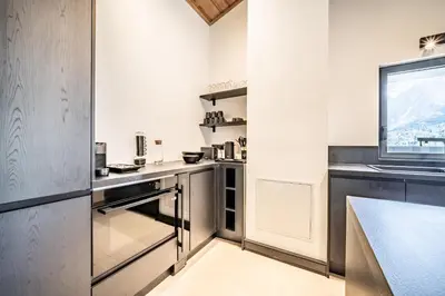 a kitchen with stainless steel appliances and a window at Apartment Cerna Les Houches - by EMERALD STAY in Les Houches