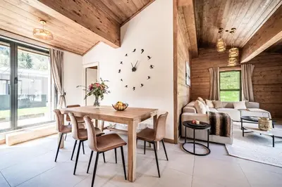 a dining room with a table and chairs and a couch at Apartment Cerna Les Houches - by EMERALD STAY in Les Houches