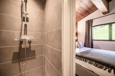 a bathroom with a shower and a bed in a room at Apartment Cerna Les Houches - by EMERALD STAY in Les Houches