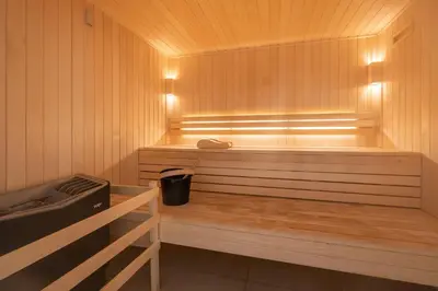 a sauna with a bench with a trash can in it at Apartment Cerna Les Houches - by EMERALD STAY in Les Houches