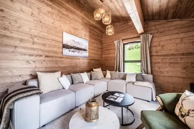 a living room with a white couch and wooden walls at Apartment Cerna Les Houches - by EMERALD STAY in Les Houches