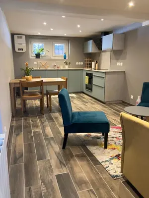 a kitchen and living room with a table and chairs at Rare, charmant T3 de 63m2, calme dans une maison, place de parking comprise in Chamonix-Mont-Blanc