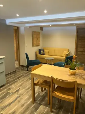 a living room with a couch and tables at Rare, charmant T3 de 63m2, calme dans une maison, place de parking comprise in Chamonix-Mont-Blanc