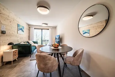a living room with a table and chairs at Apartment Omas Les Houches - by EMERALD STAY in Les Houches