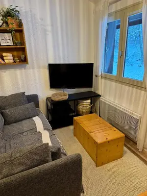 a living room with a couch and a table at Les Airelles 402 in Arâches-la-Frasse